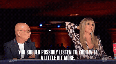 Man And Woman Sitting At Microphones Saying You Should Possibly Listen To Your Wife GIF