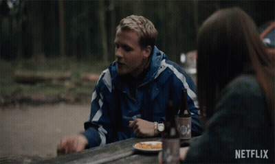Man And Woman Sitting At Picnic Table With Plate Of Food GIF