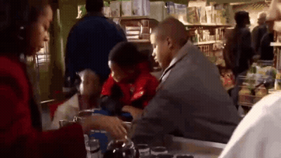 Man And Woman Sitting At Store Counter GIF