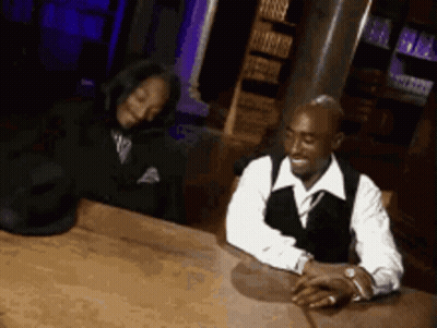 Man and Woman Sitting at Table Hands Folded