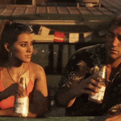 Man And Woman Sitting At Table Holding Alcohol Bottles GIF