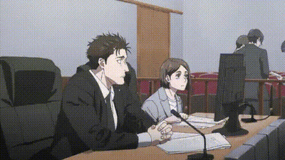 Man And Woman Sitting At Table In Courtroom GIF