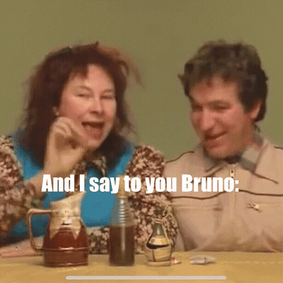 Man And Woman Sitting At Table Saying Bruno GIF