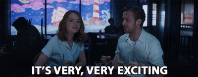 Man And Woman Sitting At Table Saying It's Very Very Exciting GIF