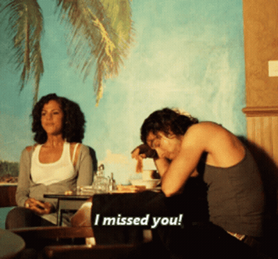 Man And Woman Sitting At Table Says I Missed You GIF