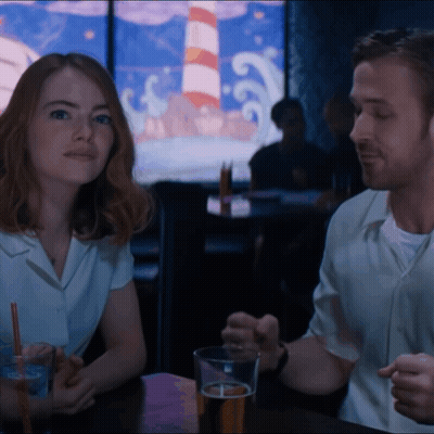 Man And Woman Sitting At Table With Beer GIF