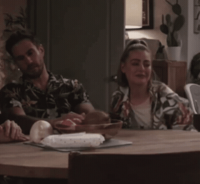 Man And Woman Sitting At Table With Bowl Of Fruit GIF