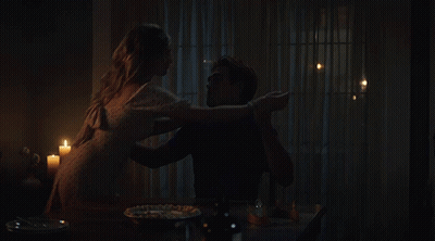 Man And Woman Sitting At Table With Candles GIF