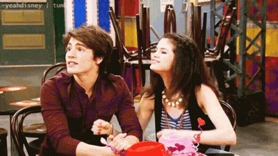 Man And Woman Sitting At Table With Disney Logo GIF