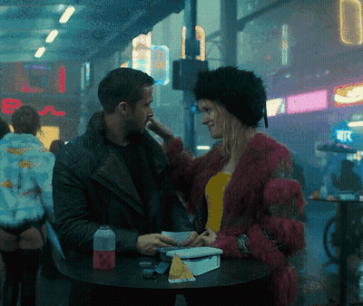 Man And Woman Sitting At Table With E Sign GIF
