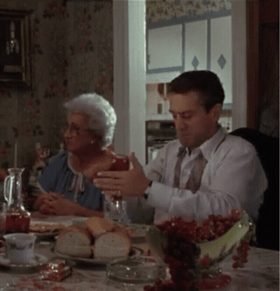 Man And Woman Sitting At Table With Food And Drinks GIF