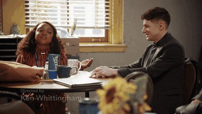 Man And Woman Sitting At Table With Ken Whittingham GIF