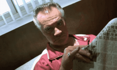 Man And Woman Sitting At Table With Lamp GIF