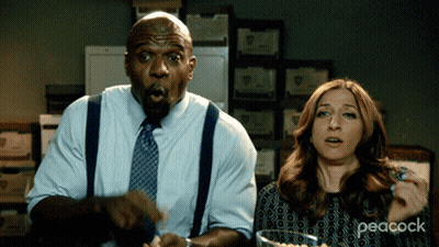 Man And Woman Sitting At Table With Peacock GIF
