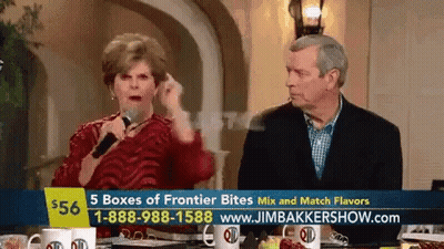 Man And Woman Sitting At Table With Sign Saying 5 Boxes Of Frontier Bites GIF