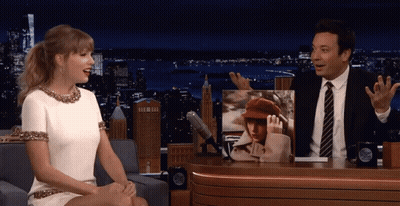 Man And Woman Sitting At Table With Taylor Swift Picture GIF