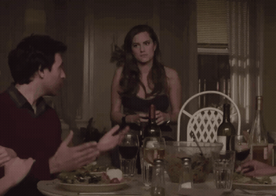 Man And Woman Sitting At Table With Wine Glasses GIF