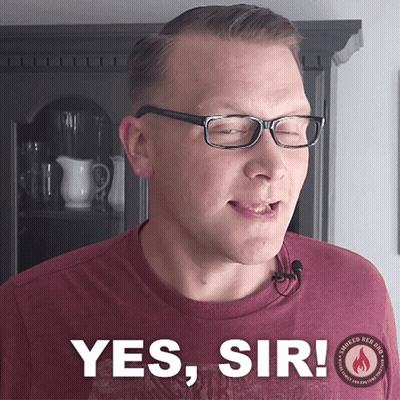Man And Woman Sitting At Table Woman Wearing Share The Love Shirt GIF