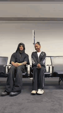 Man And Woman Sitting In Airport Waiting Area GIF