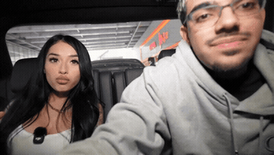 Man And Woman Sitting In Car In Front Of ABC Sign GIF