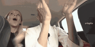 Man And Woman Sitting In Car With Arms In Air GIF