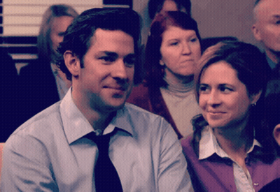 Man And Woman Sitting In Crowd GIF