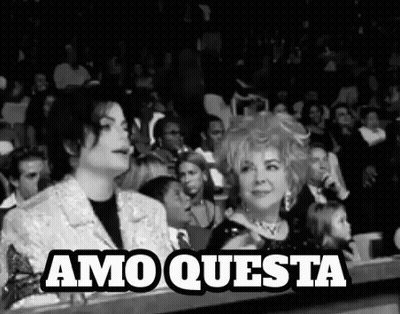 Man And Woman Sitting In Crowd GIF