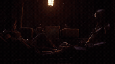 Man And Woman Sitting In Dark Room GIF