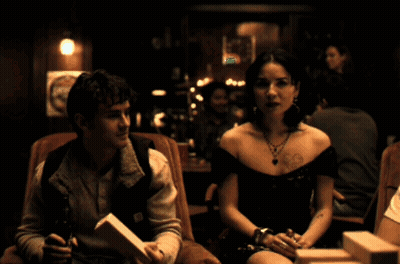 Man And Woman Sitting In Dark Room Man Wearing Carhartt Vest GIF