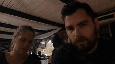 Man And Woman Sitting In Dark Room GIF