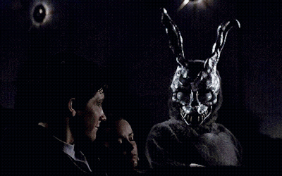 Man And Woman Sitting In Dark Room With Rabbit Mask GIF