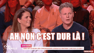Man And Woman Sitting In Front Of Crowd Saying Ah Non C'est Dur La GIF