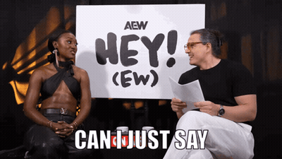 Man And Woman Sitting In Front Of Hey Ew Sign GIF