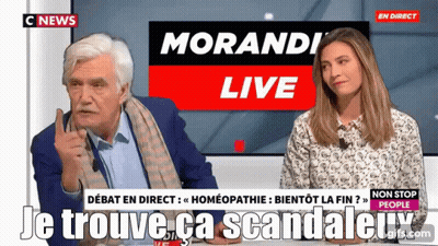Man And Woman Sitting In Front Of Morandi Live Screen GIF