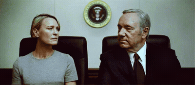 Man And Woman Sitting In Front Of President Seal GIF