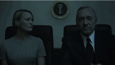 Man And Woman Sitting In Front Of White House Seal GIF