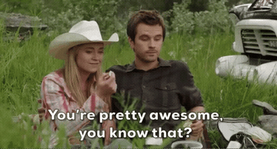 Man And Woman Sitting In Grass With Truck And Cowboy Hat GIF
