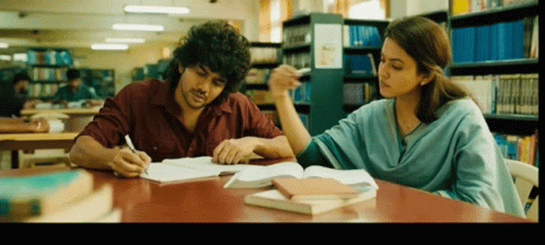 Man and Woman Sitting in Library