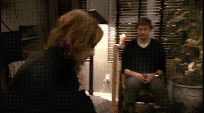 Man And Woman Sitting In Living Room GIF