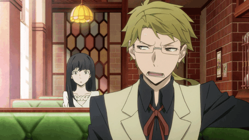 Man And Woman Sitting In Room With Brick Wall GIF