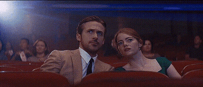 Man And Woman Sitting In Theater GIF