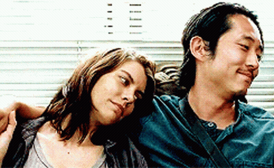Man And Woman Sitting Looking At Camera GIF