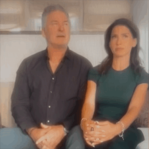 Man And Woman Sitting Next To Each Other With Hands Folded GIF