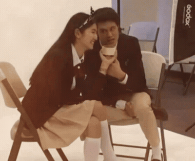 Man And Woman Sitting Next To Godox Light GIF