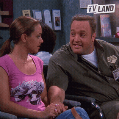 Man And Woman Sitting Next To TV Land Logo GIF