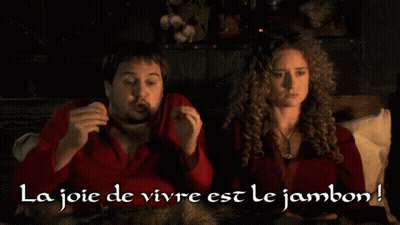 Man And Woman Sitting On Bed La Joie De Vivre Est Le Jambon GIF