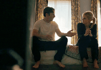Man And Woman Sitting On Bed Talking GIF