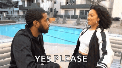 Man And Woman Sitting On Bench By Pool Woman Saying Yes Please GIF