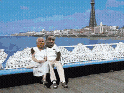 Man And Woman Sitting On Bench With Tower GIF