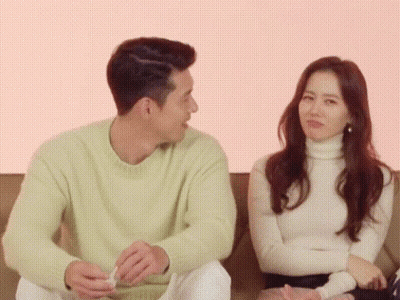 Man And Woman Sitting On Couch GIF